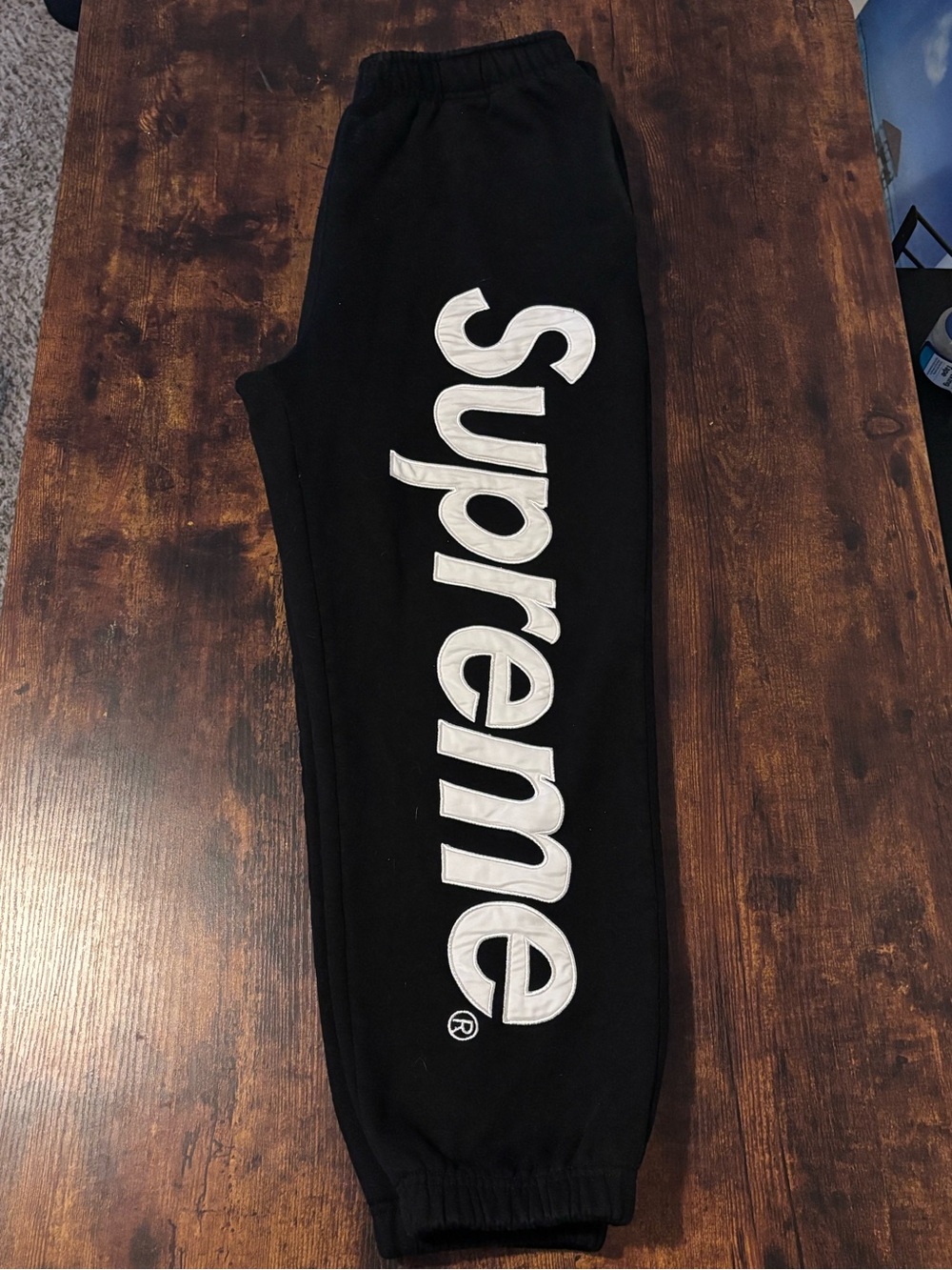 Supreme Black Sweatpants with Large White Vertical Logo